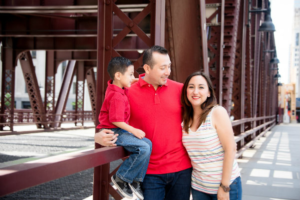 Family standing on a bridge