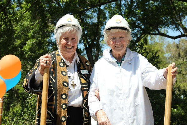 Two nuns with shovels