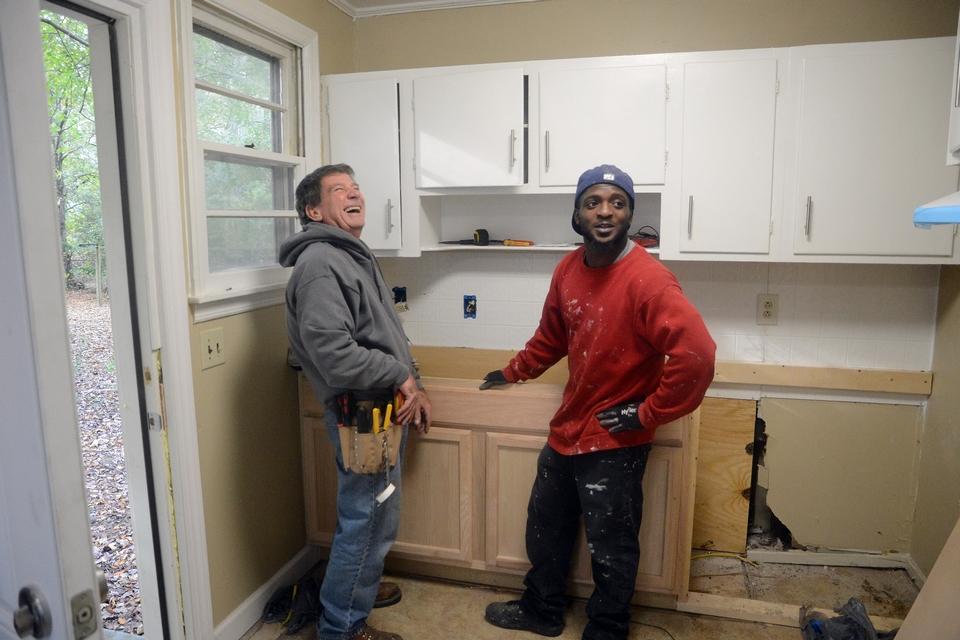 Two men rehabilitate a home