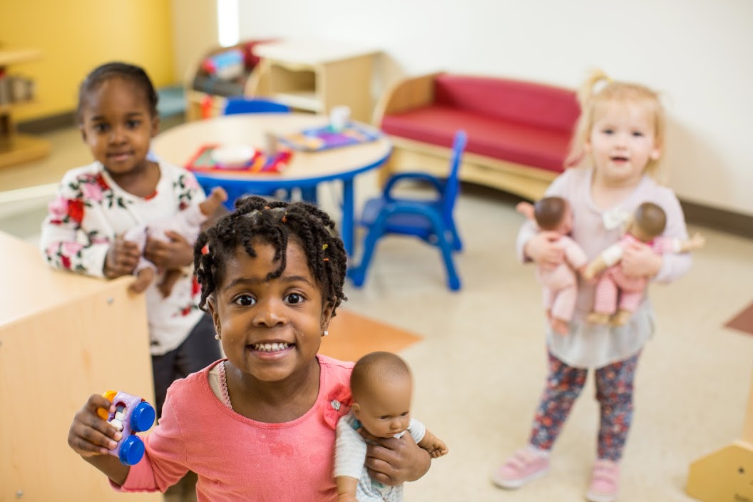 Happy children playing with dolls