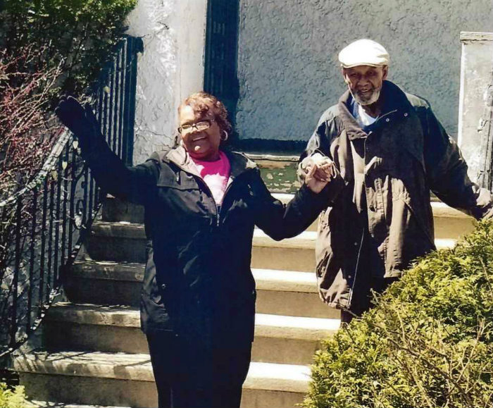 Happy couple on stairs of home