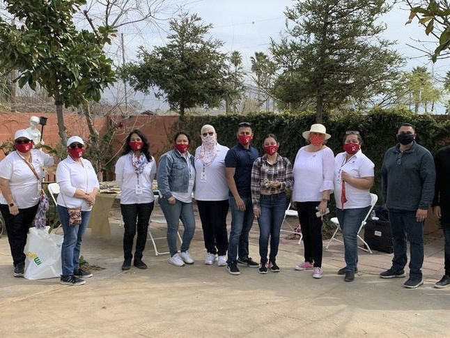 Fed-staff-volunteer-at-vax-site---FB-croppedOPTIMIZED Volunteers in California's Kern County, including staff from Self-Help's Lamont Branch, provide assistance at a vaccine site.