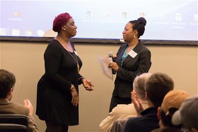 AnnualMeeting_Durham_2018_94 Stephanie Terry, left, owner of Sweeties Southern & Vegan Catering, and Latoyia Boria, Self-Help Area Manager, speak at our annual meeting