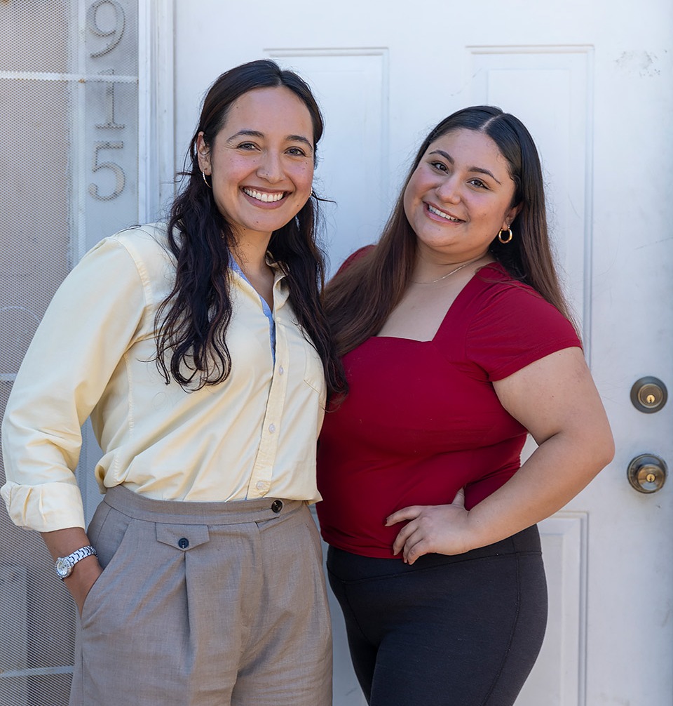 Andrea (right) and her Self-Help mortgage loan officer, Lourdes, at Andrea's new home.