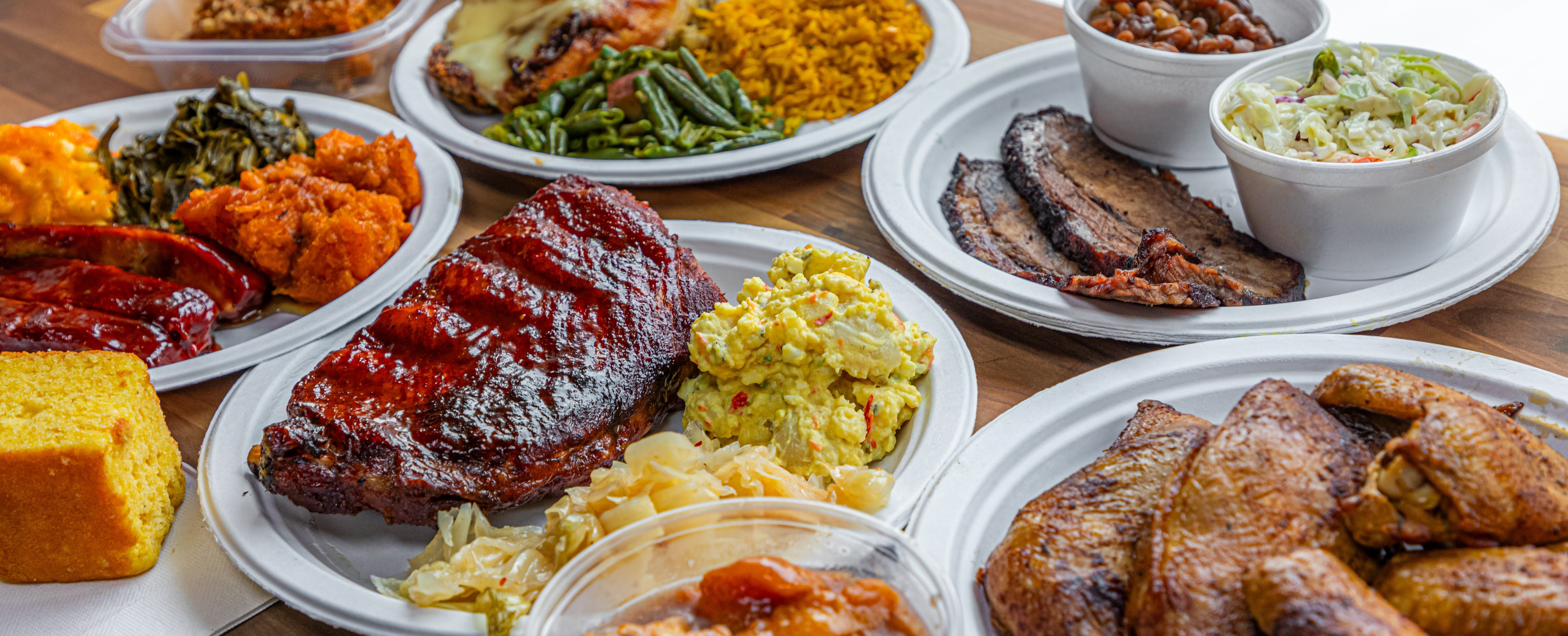 variety of BBQ foods on a wood table