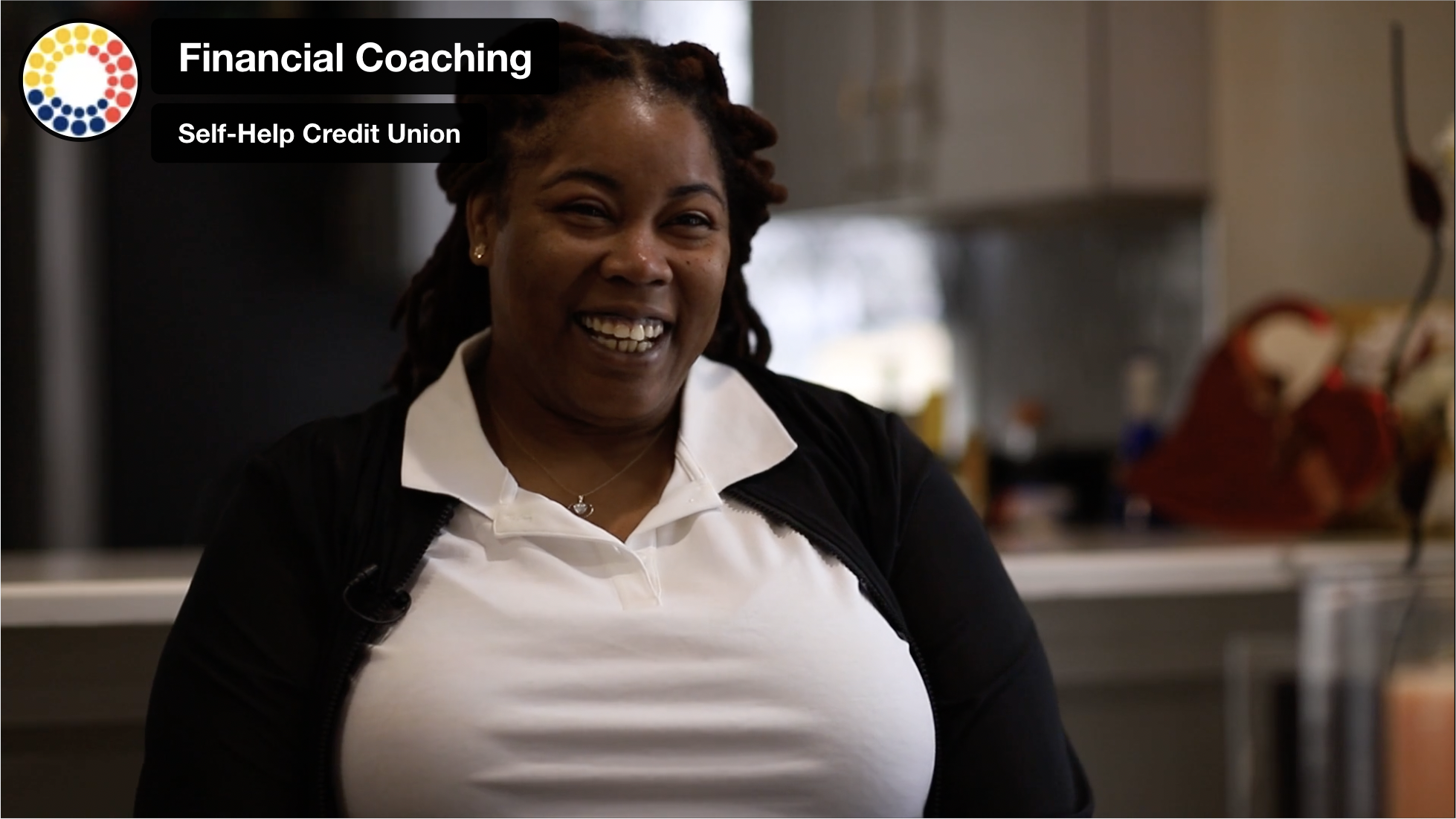 photo of a seated and smiling black woman