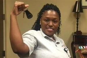 charlene---2017-homeowner-crop-2 Woman holds house keys after mortgage closing.