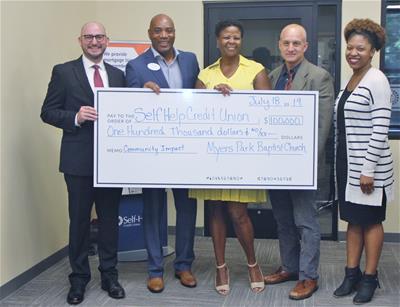 Charlotte GrOp Deposit Check Meyers Park Baptist Church in Charlotte presented Self-Help CU with a deposit of $100,000.