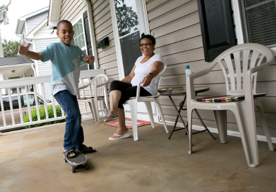 kid playing on porch with grandmother