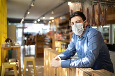Small business owner wearing COVID mask
